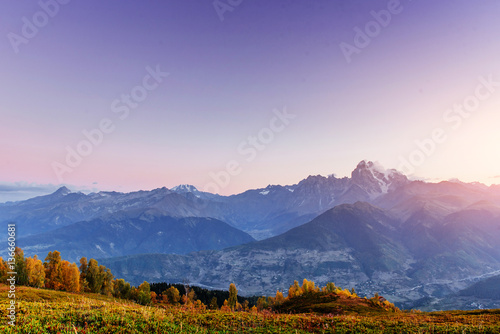 Magic autumn landscape and snow-capped mountain peaks. View of t © standret
