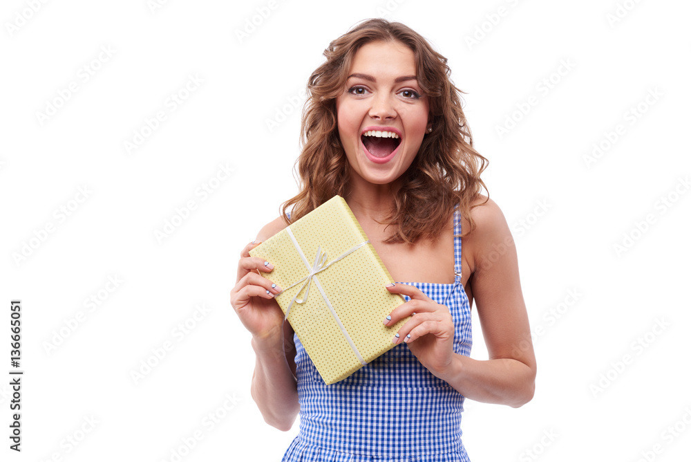 Astonished youth holding a gift box in hands Astonished youth holding a gift box in hands