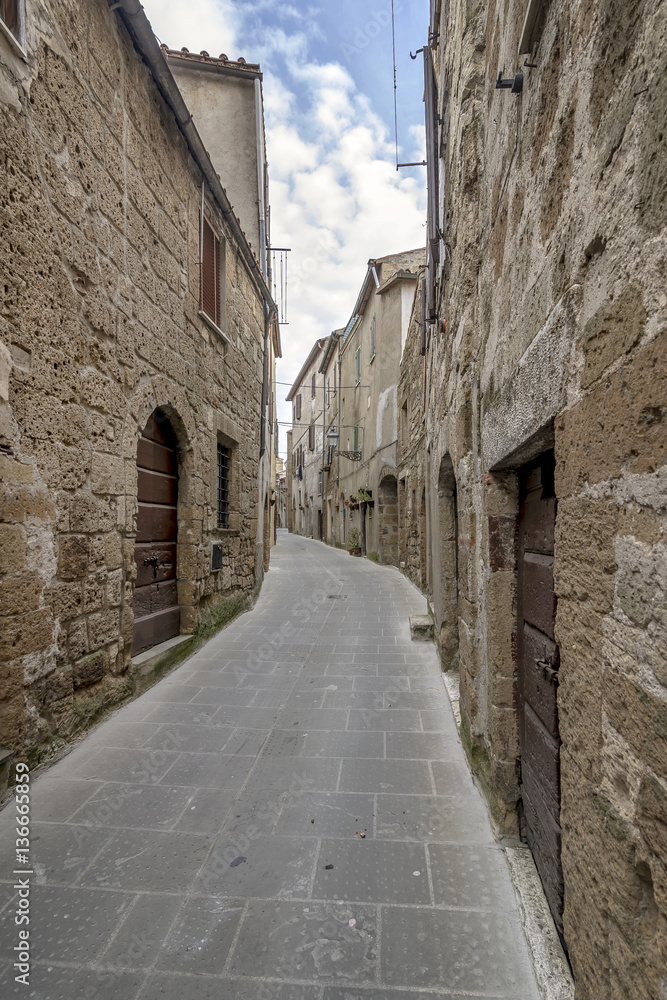 A typical narrow alley in the historic center of Pitigliano, Grosseto, Tuscany, Italy