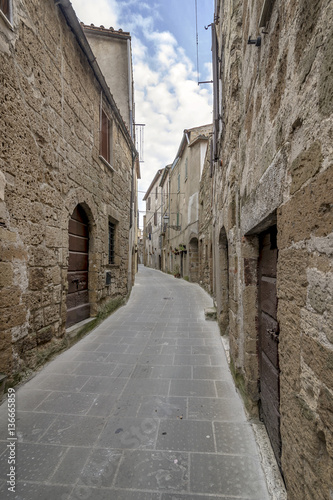 A typical narrow alley in the historic center of Pitigliano  Grosseto  Tuscany  Italy