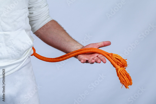 Athlete shows orange belt capoeira