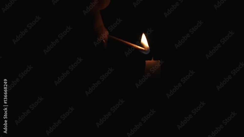 Slow motion of lighting tall candle in the dark, 180fps prores footage Slow motion of lighting tall candle in the dark, 180fps prores footage