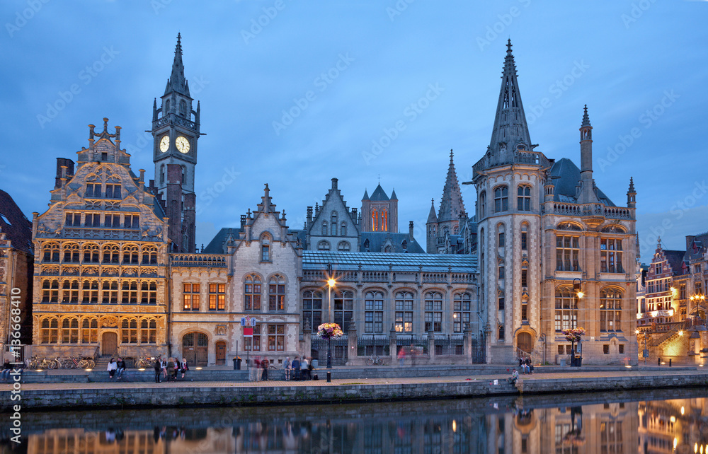 GHENT, BELGIUM - JUNE 23, 2012: Typical old palaces from Graselei street from 16. - 18. cent. and west facade of Post palace at dusk.