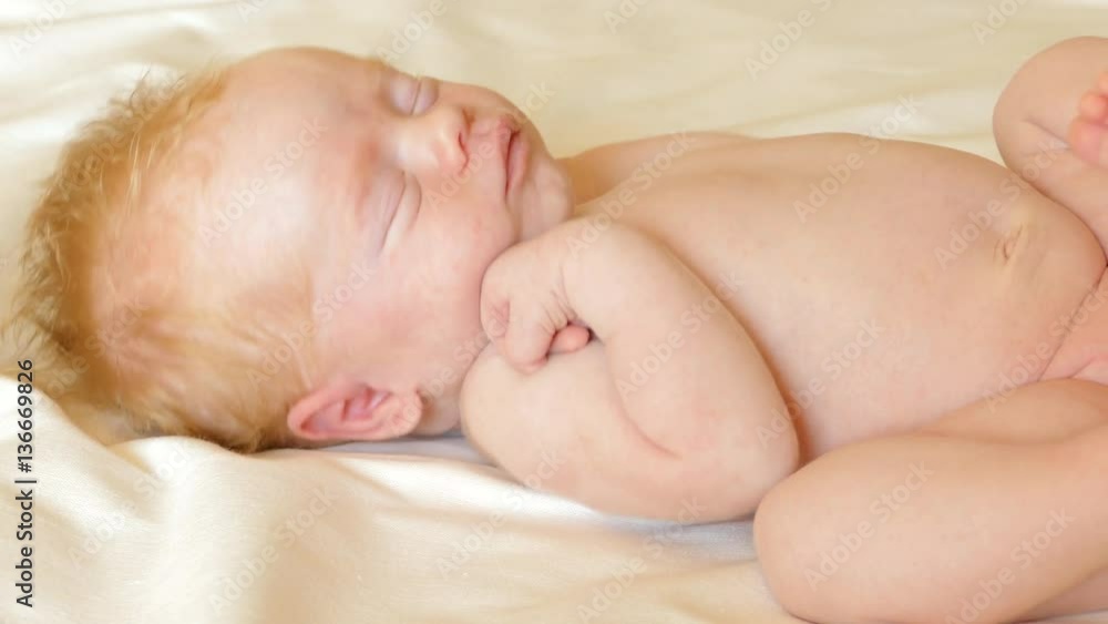 Little newborn baby tossing and turning in his sleep Little newborn baby tossing and turning in his sleep