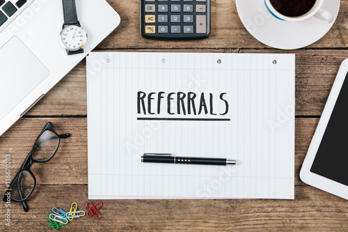 referrals on notebook on Office desk with computer technology, h photo