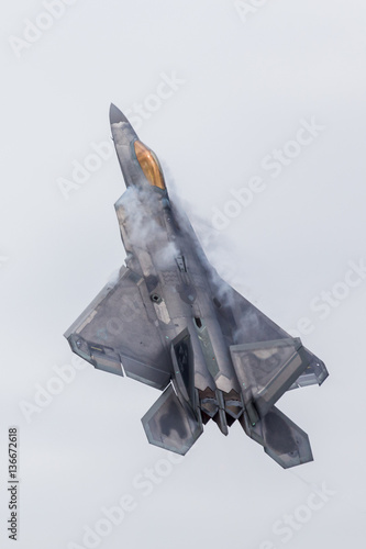 The F-22A Raptor stealth fighter pulls straight into the vertica photo
