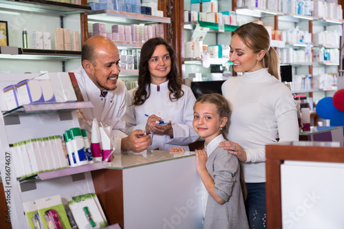 Two pharmacists and customers.