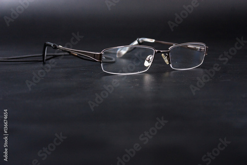 light reading glasses on a black background