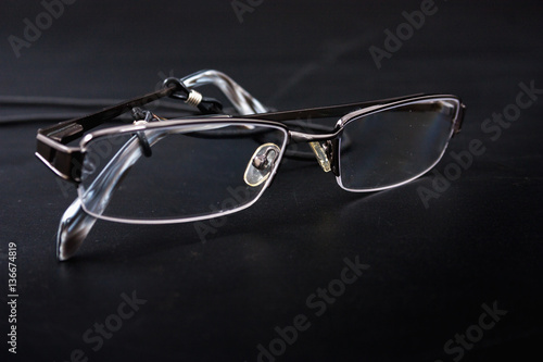 light reading glasses on a black background