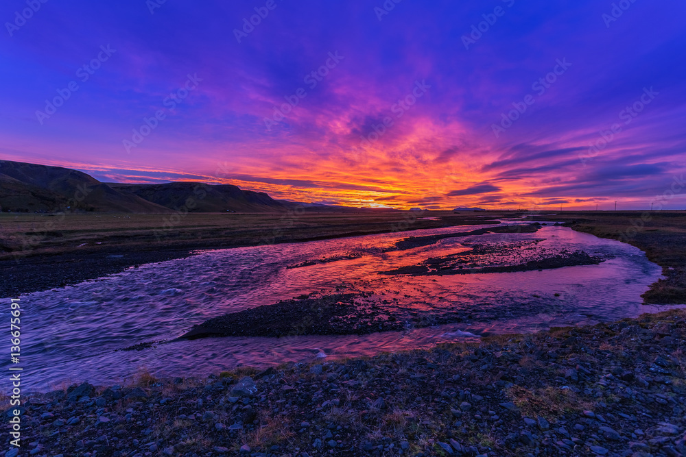 Sunrise over the wild river. Landscape in Iceland, colored sky s