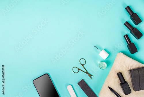 Top view of manicure and pedicure equipment on blue background