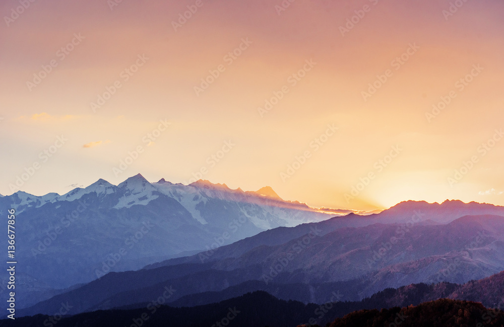 Autumn landscape and snow-capped mountain peaks. View of the mou