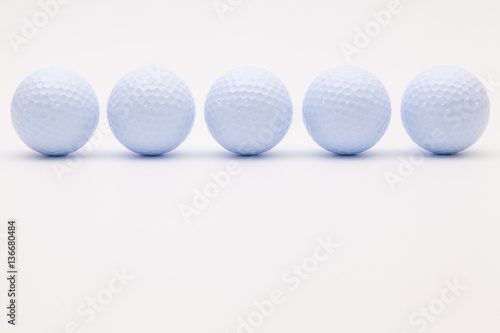 White golf balls on the white background.