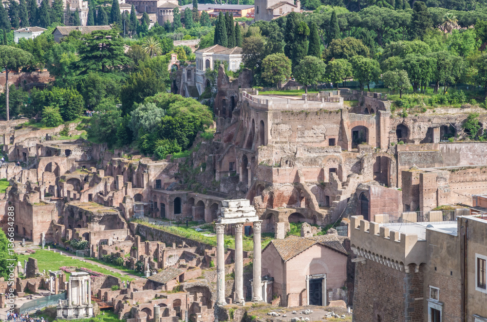 The Roman Forum is a plaza surrounded by many ruins of ancient government buildings in the center of Rome