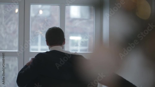 Groom puts on a jacket