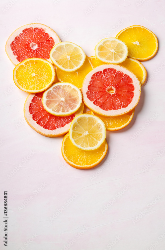 Citrus fruit Heart from slices of lemon, orange, grapefruit on white background. Love, healthy, ecology concept. Citrus fruit Heart from slices of lemon, orange, grapefruit on white background. Love, healthy, ecology concept.
