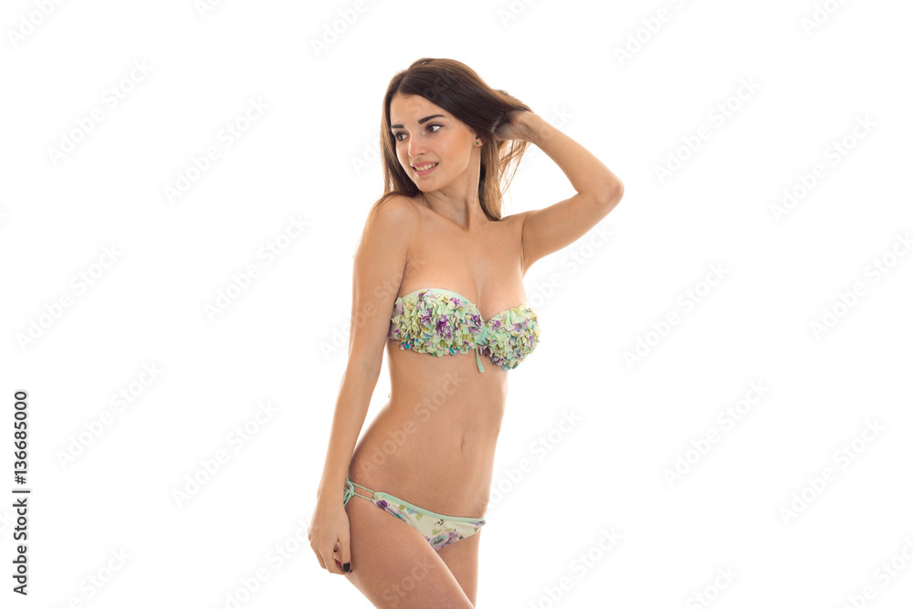 sexy young woman with big natural breast in swimsuit with floral pattern looking away and smiling isolated on white background sexy young woman with big natural breast in swimsuit with floral pattern looking away and smiling isolated on white background