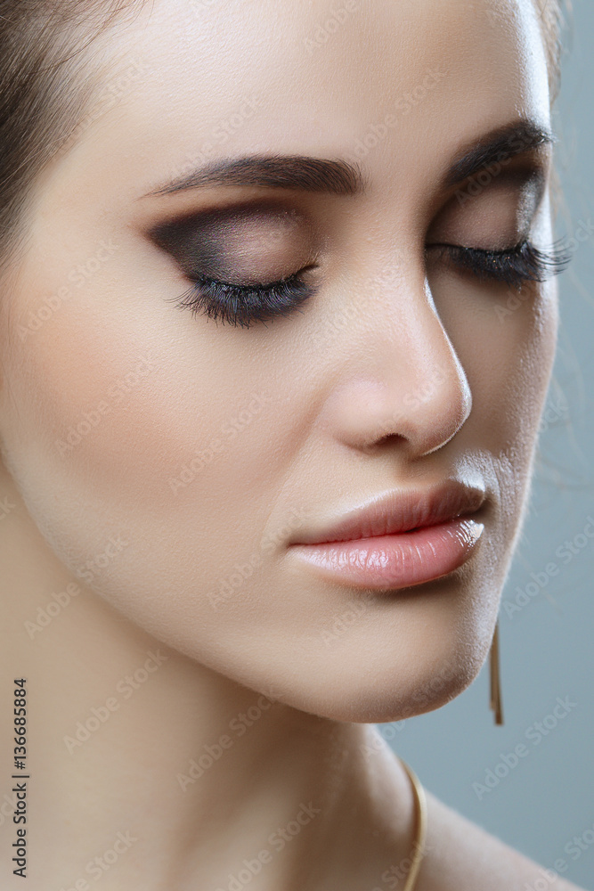 Closeup image of closed woman eye with beautiful bright makeup, smoky eyes