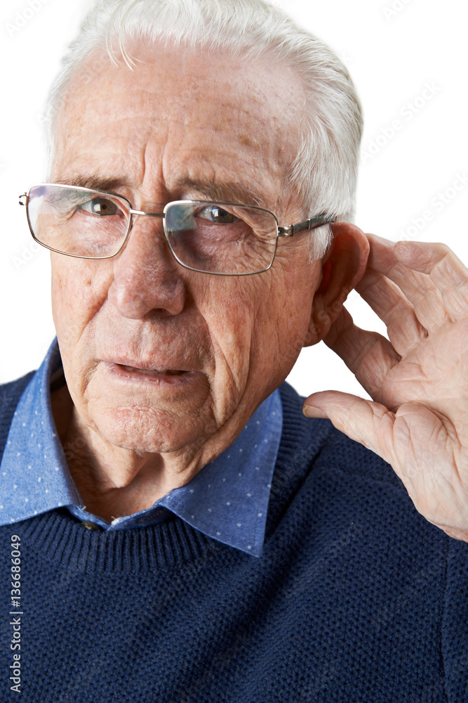 Studio Shot Of Senior Man Suffering From Deafness Studio Shot Of Senior Man Suffering From Deafness