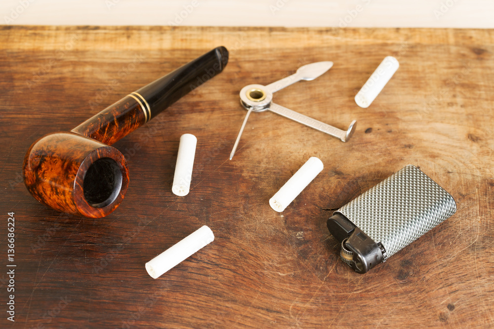 Smoking pipe on a wooden table. Aroma. Top view