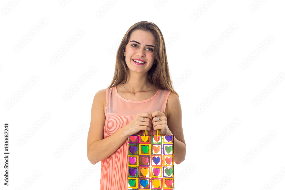 smiling young girl keeps bright colour Pack in hands isolated on white background smiling young girl keeps bright colour Pack in hands isolated on white background