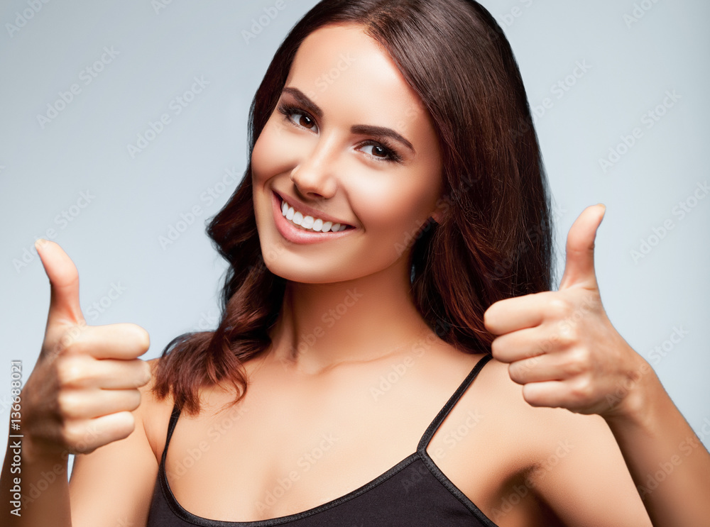 Portrait of woman showing thumb up hand sign gesture, on bright Portrait of woman showing thumb up hand sign gesture, on bright