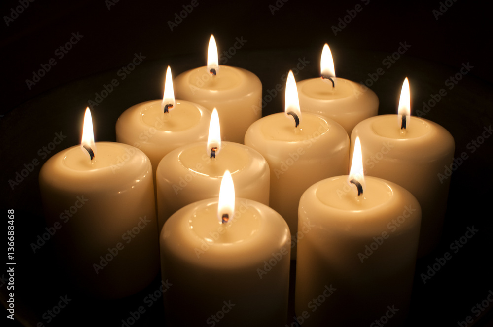 Burning wax candles closeup on dark background Burning wax candles closeup on dark background