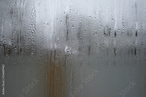 Raindrops on a window during bad, rainy weather