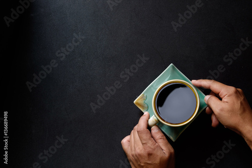 Top view with copyspace of Man hands holding Coffee  on kitchen table. Hero Header Concept with Copy space.