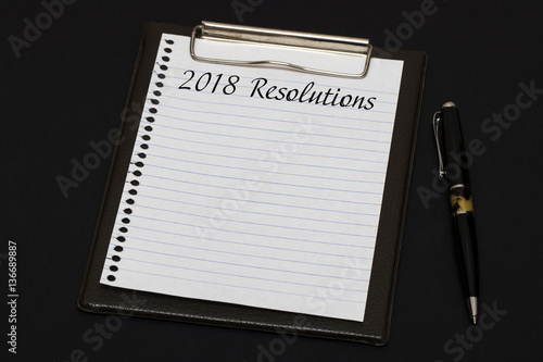 Top view of clipboard and white sheet written with 2018 Resoluti photo