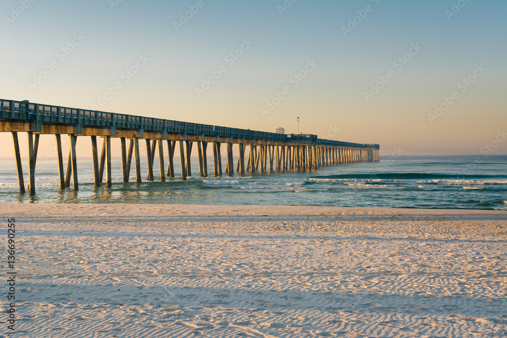 Morning light on the M.B. Miller County Pier and sandy beach alo