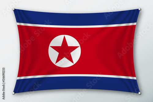 North Korea national flag. Symbol of the country on a stretched fabric with waves attached with pins. Realistic vector illustration.