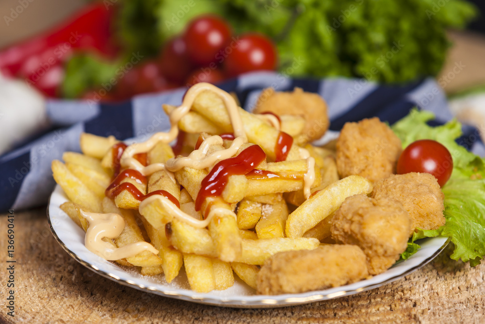 Fresh french fries, chips with tasty chicken nuggets Fresh french fries, chips with tasty chicken nuggets