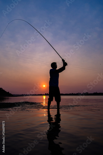 Fishermen fishing at sunset,Fishermen in Thailand.