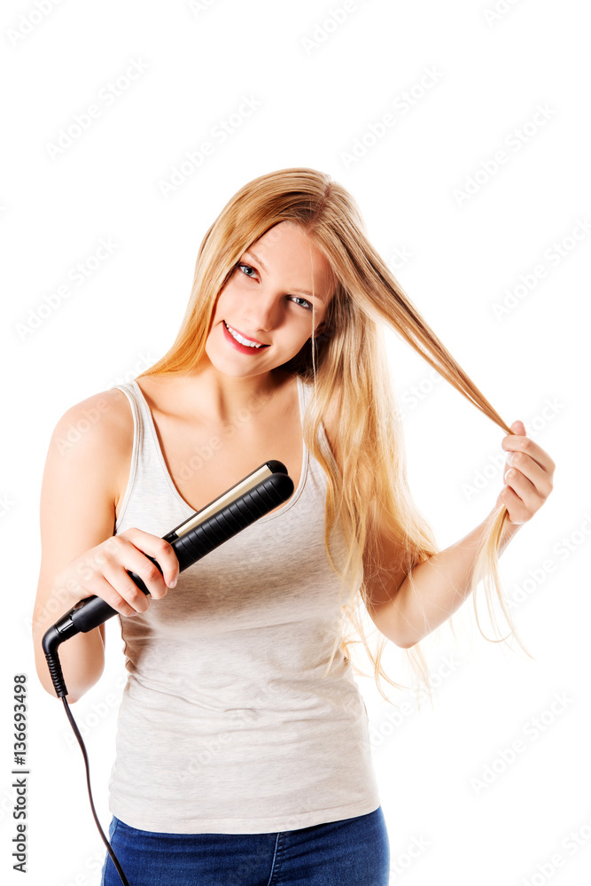 Portrait of beautiful woman using hair straighteners. Portrait of beautiful woman using hair straighteners.