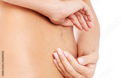 Hands on slim female belly
