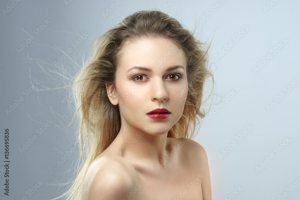 Beautiful young female face. Studio shot. Beautiful young female face. Studio shot.