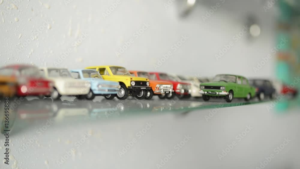 collection of toy cars on the glass shelf. camera focus moves on cars collection of toy cars on the glass shelf. camera focus moves on cars