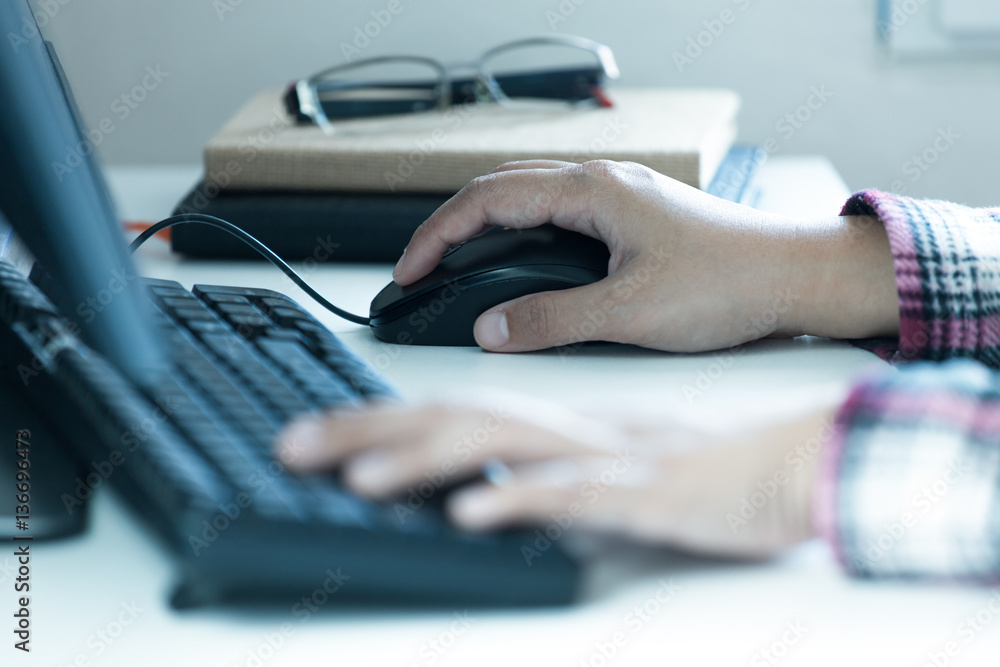 Woman's hands click on computer mouse Woman's hands click on computer mouse
