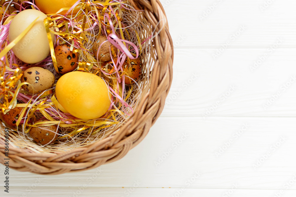 Easter colored eggs in the basket on white background Easter colored eggs in the basket on white background