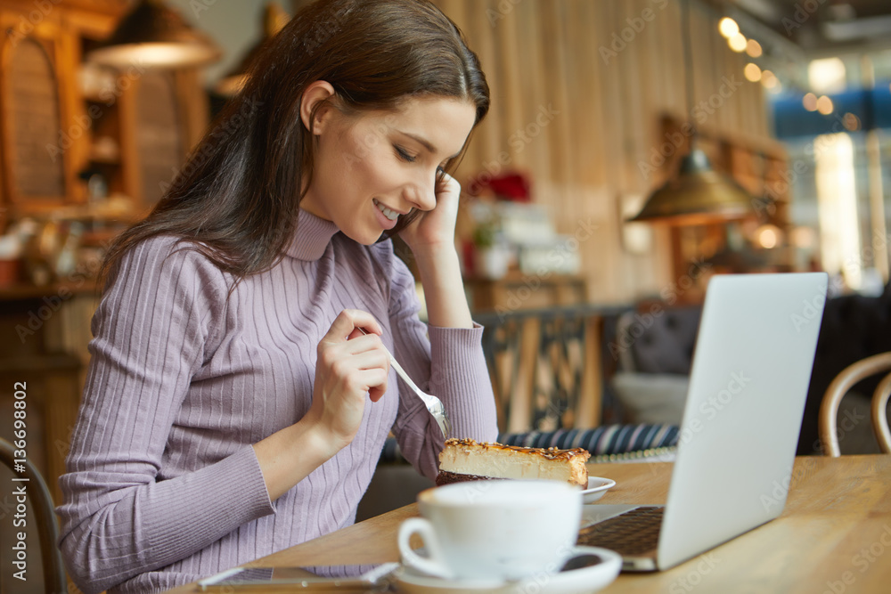 Beautiful brunette using laptop in cafe. Blogger work concept Beautiful brunette using laptop in cafe. Blogger work concept