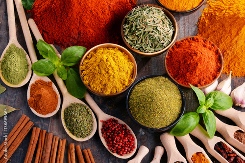 Variety of spices and herbs on kitchen table photo