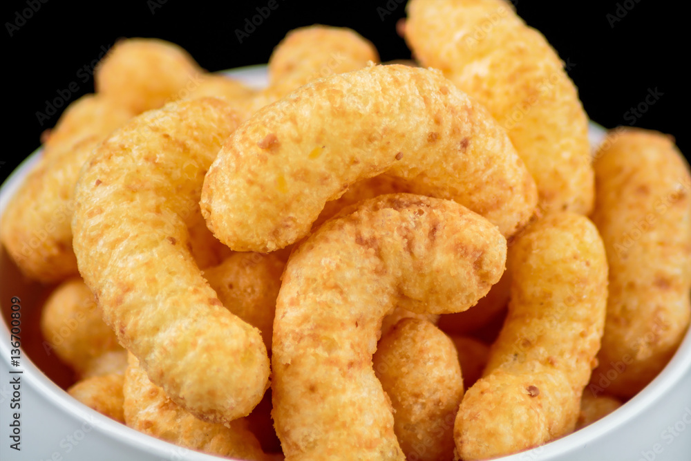 Flips snack in the white mug on black background Flips snack in the white mug on black background