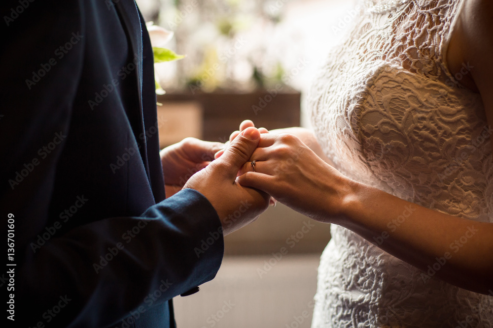 Obraz premium Wedding couple holding hands, bride and groom in love