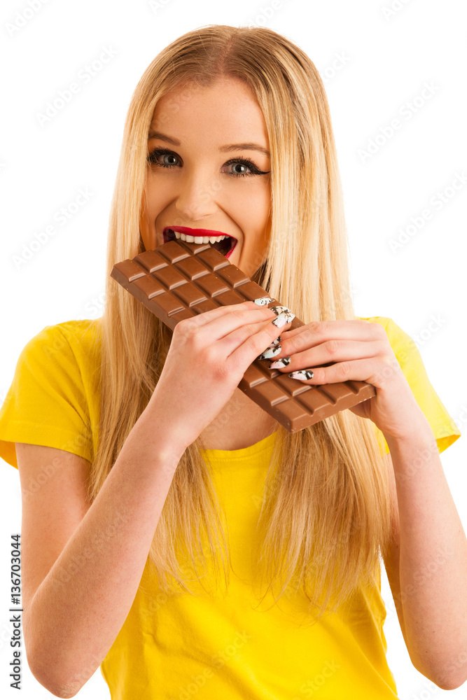 Cute young woman eating chocolate isolated over white background