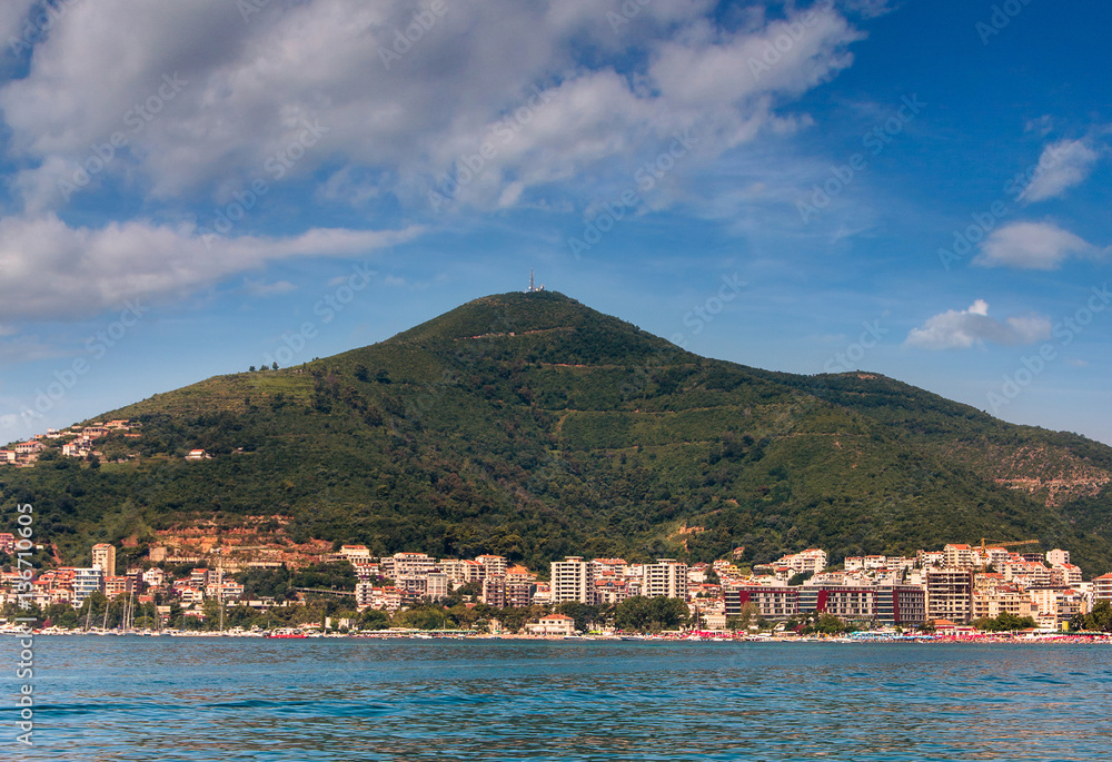 View of the town of Budva, sea bay and mountains distance in summertime. Montenegro. Balkans, Adriatic sea, Europe.