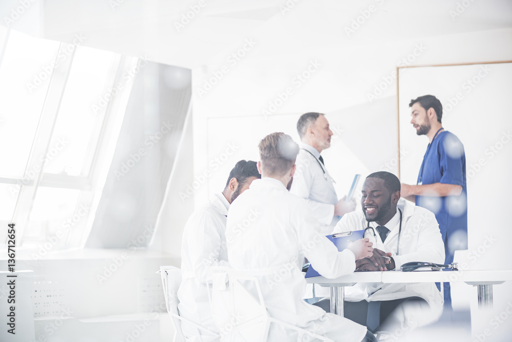Outgoing physicians deliberating at conference Outgoing physicians deliberating at conference
