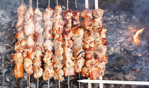 shish kebab on skewers on the grill with flames