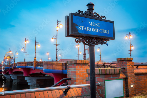 Sign "most staromiejski", birdge and observation tower at the background; Gorzow Wlkp. Polska at the twilight