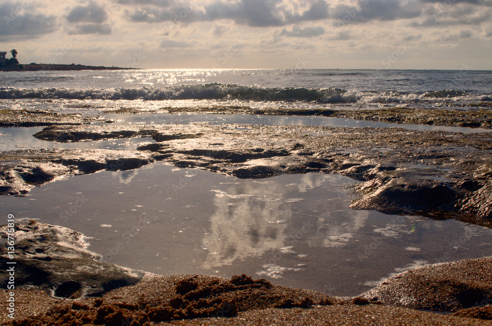 Puddles on the beach at sunset. Puddles on the beach at sunset.